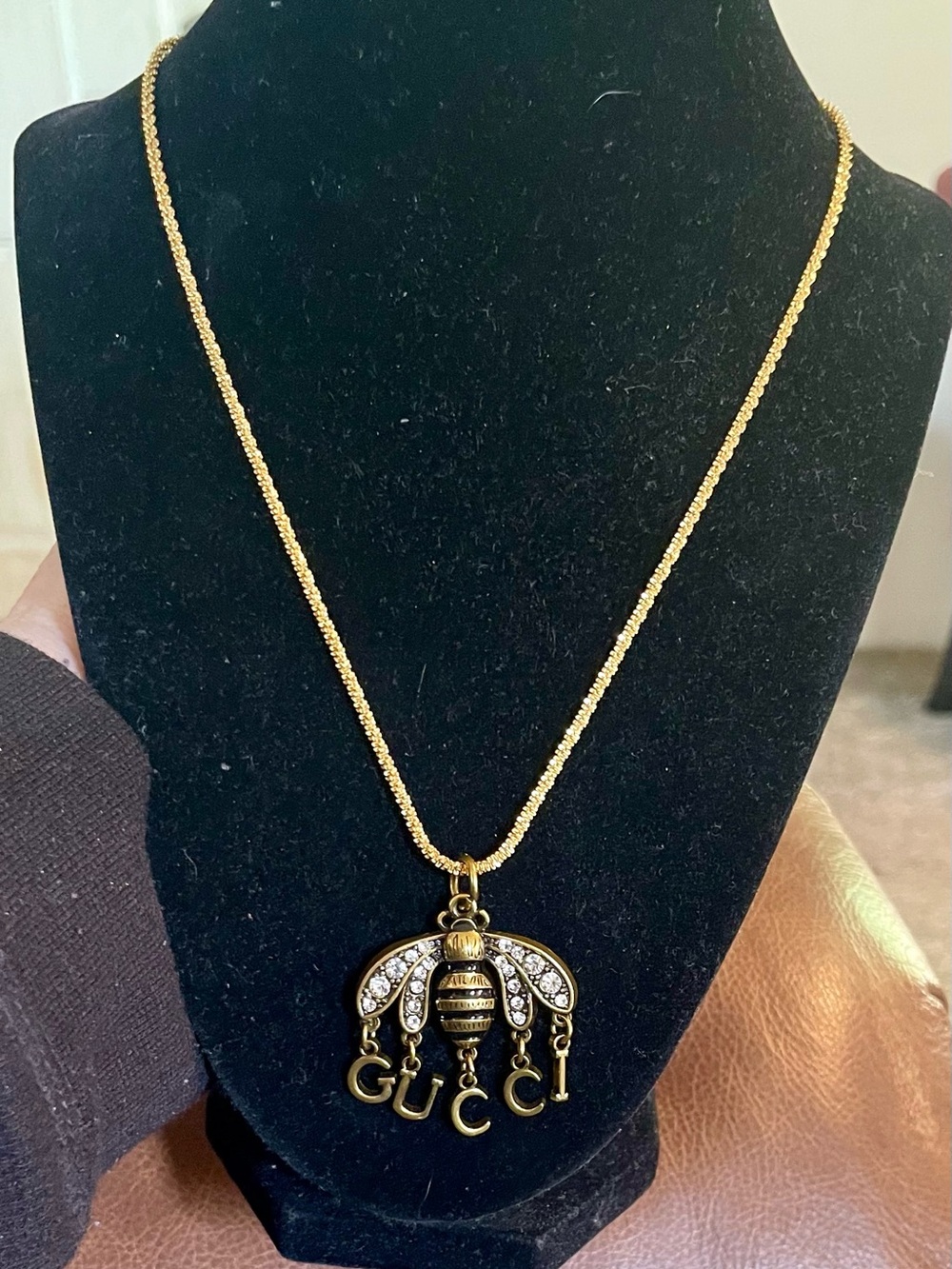 Gucci elegant bee necklace on gold chain with roses and gift box.
